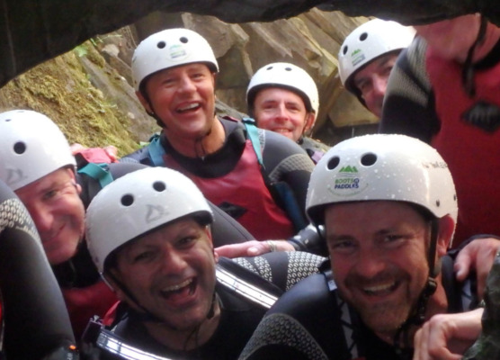 a group of guys smile for the camera on a gorge adventure