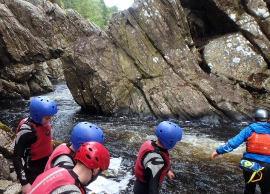 scrambling through a river gorge