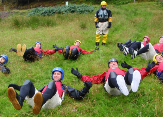 group practicing their floating technique on the river bank before starting a gorge adventure